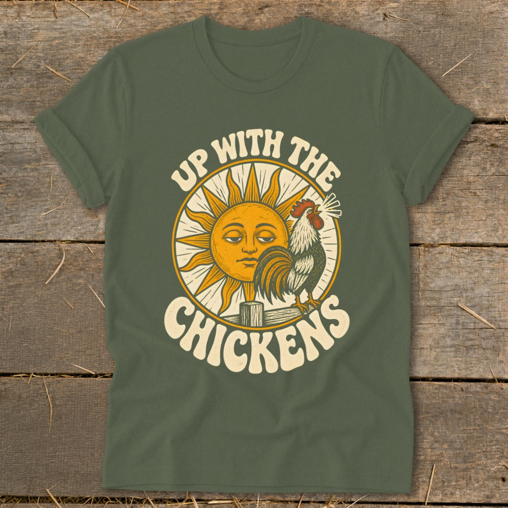 Olive green t-shirt with a retro graphic of a sun, a rooster, and the text Up With The Chickens.