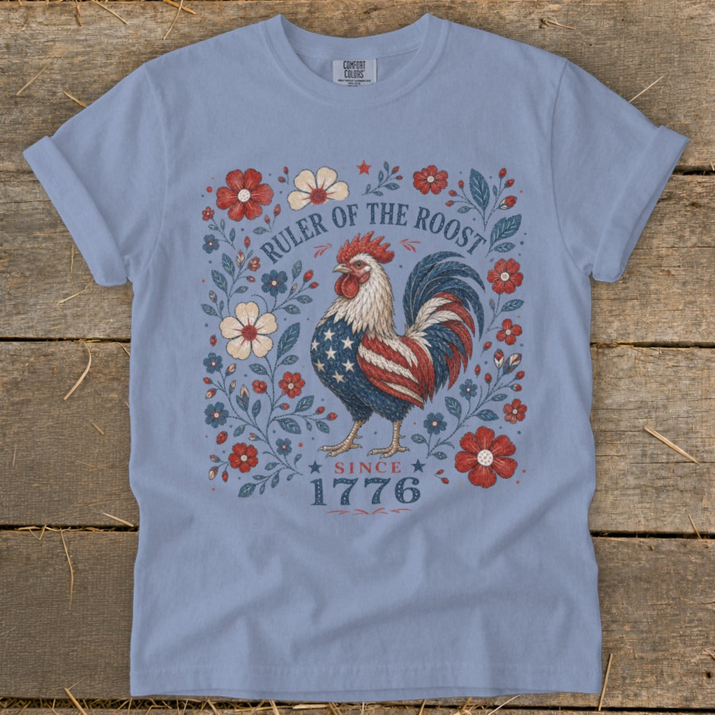 Light blue t-shirt with a patriotic rooster and floral design saying "Ruler of the Roost Since 1776".