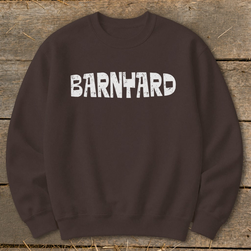 A dark brown crewneck sweatshirt with distressed white text reading "BARNYARD" centered on the chest.