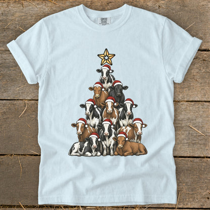 Light blue t-shirt with a Christmas tree made of cows wearing Santa hats.