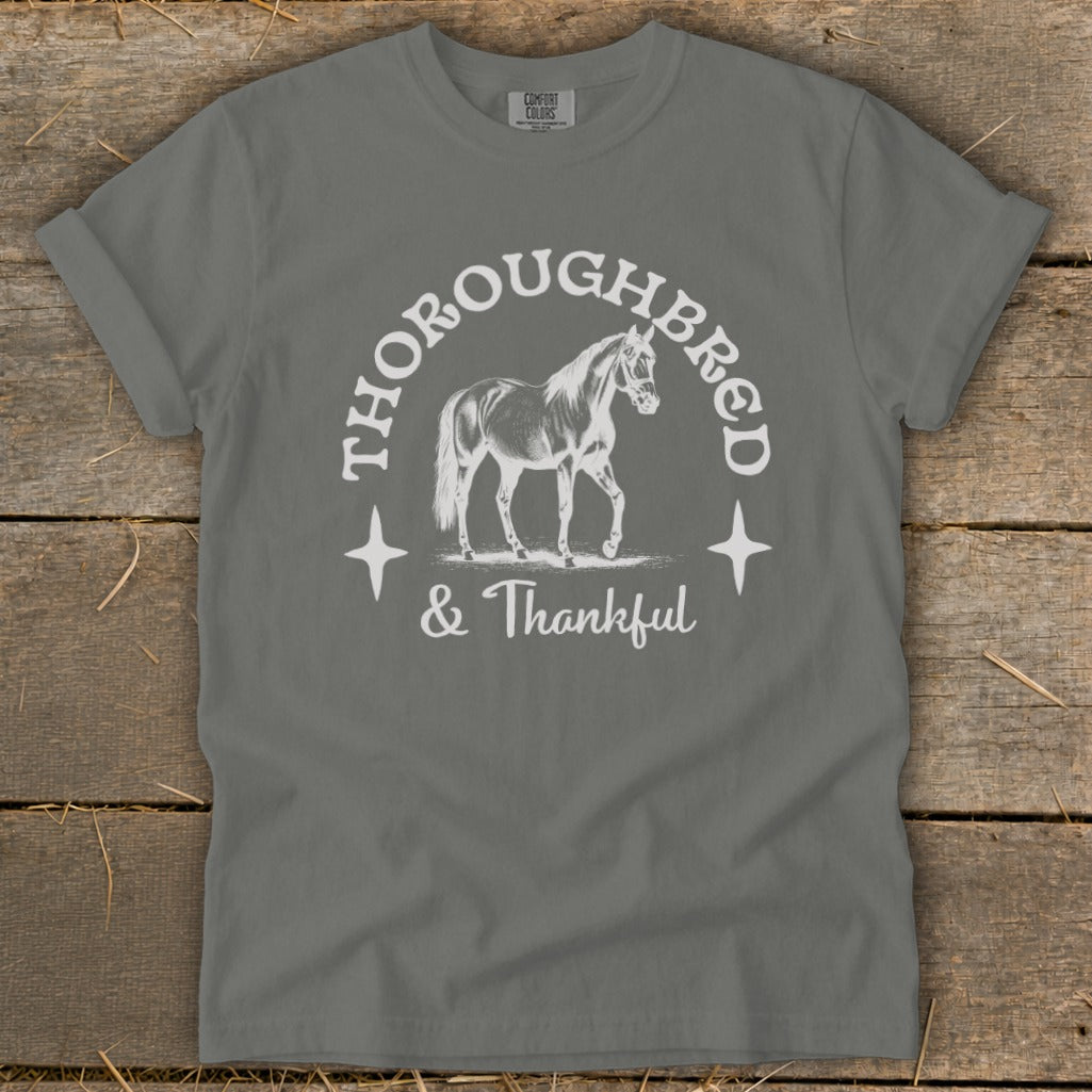 Gray t-shirt with white graphic of a horse, "Thoroughbred," and "& Thankful."