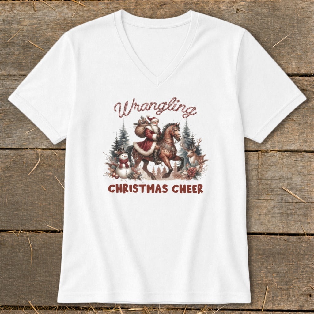 White t-shirt with Santa on a horse, snowman, reindeer, and text "Wrangling Christmas Cheer".