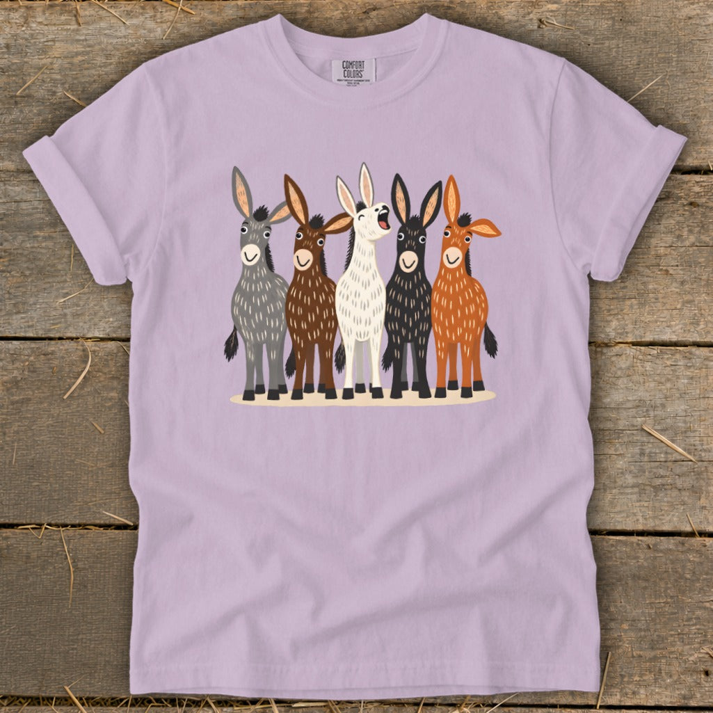 A light purple t-shirt featuring a graphic of five illustrated donkeys standing in a row.