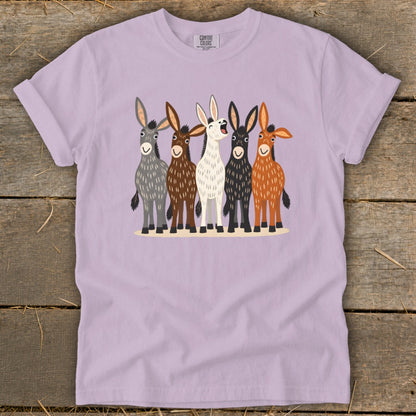 A light purple t-shirt featuring a graphic of five illustrated donkeys standing in a row.
