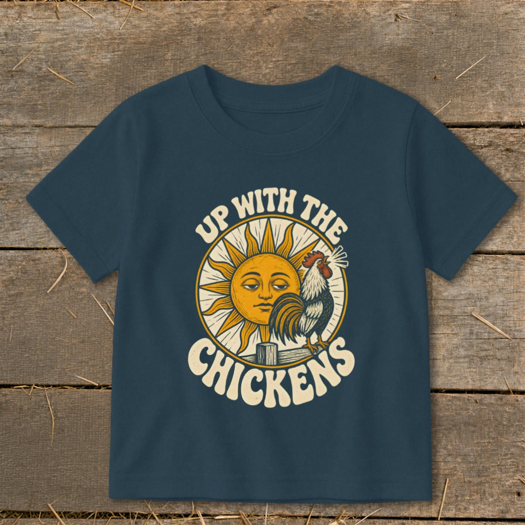 A dark blue t-shirt with a vintage graphic reading Up With The Chickens, featuring a rooster and a sun.
