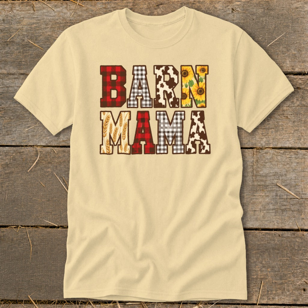 Cream t-shirt with "BARN MAMA" text featuring cow print, sunflowers, plaid, and wheat designs.