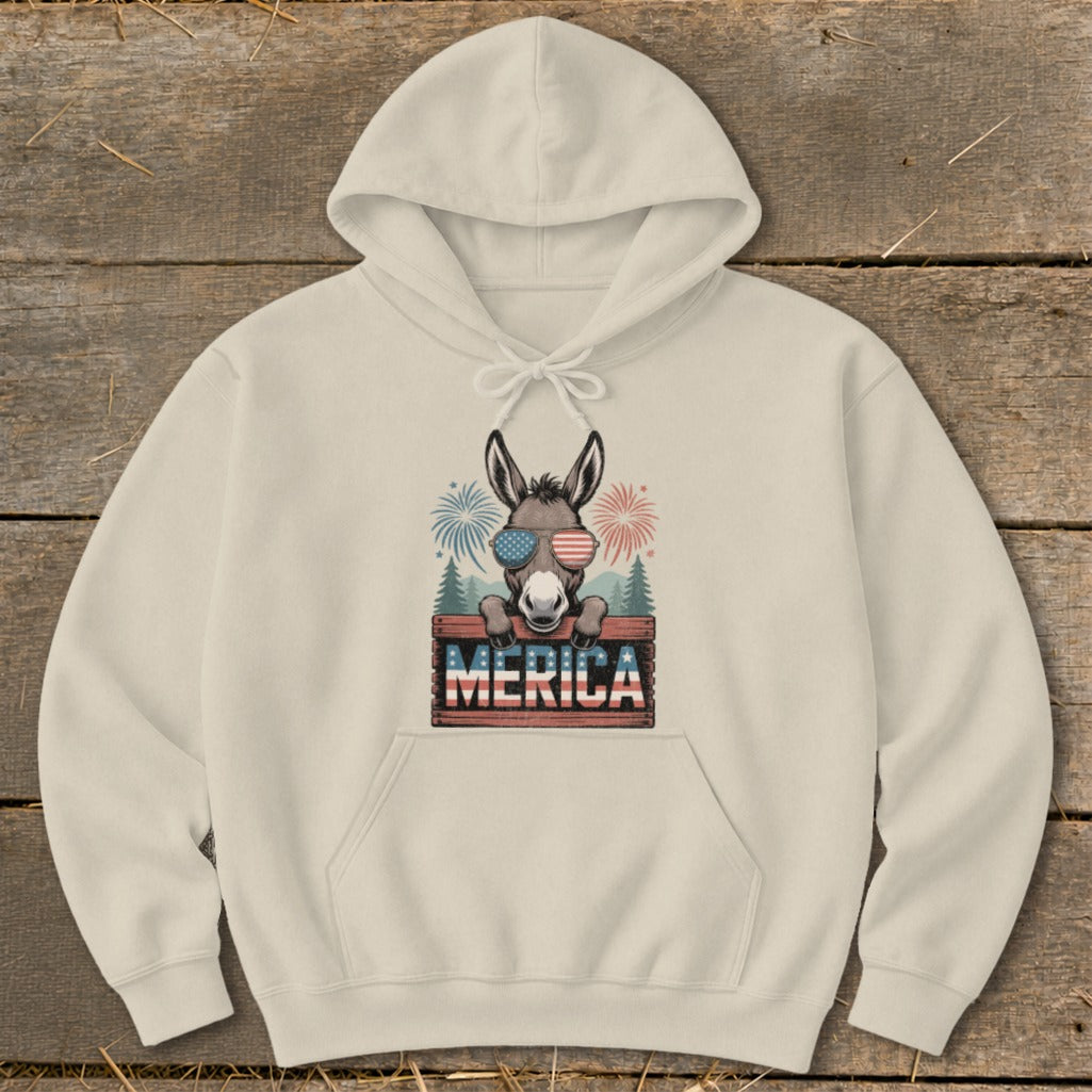 Donkey wearing American flag sunglasses on a cream hoodie with "MERICA" text.