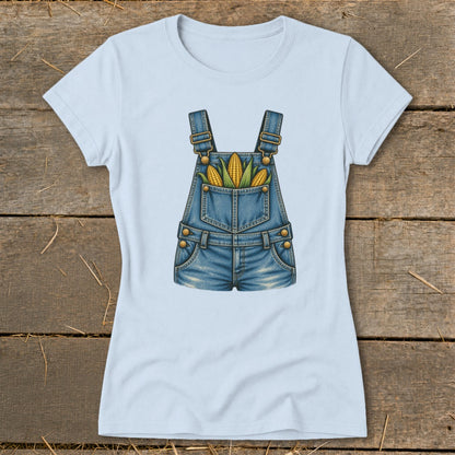 Light blue t-shirt with denim overalls graphic featuring corn in the pockets.