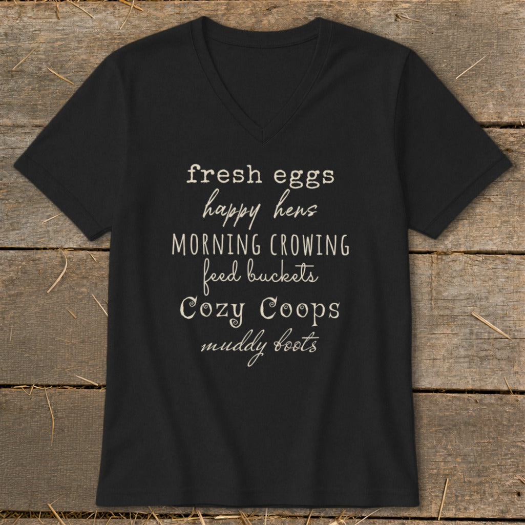 Black v-neck t-shirt with text "fresh eggs happy hens MORNING CROWING feed buckets Cozy Coops muddy boots".