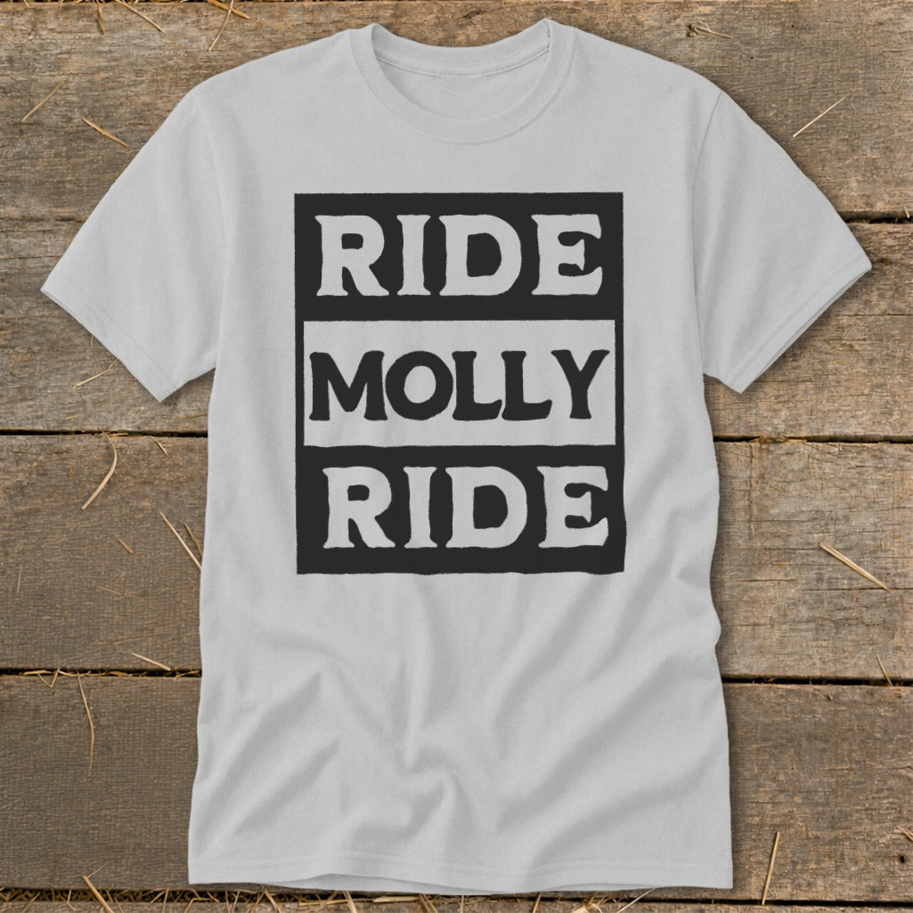 A light gray t-shirt featuring a black block design with the text RIDE MOLLY RIDE on a rustic wooden background.