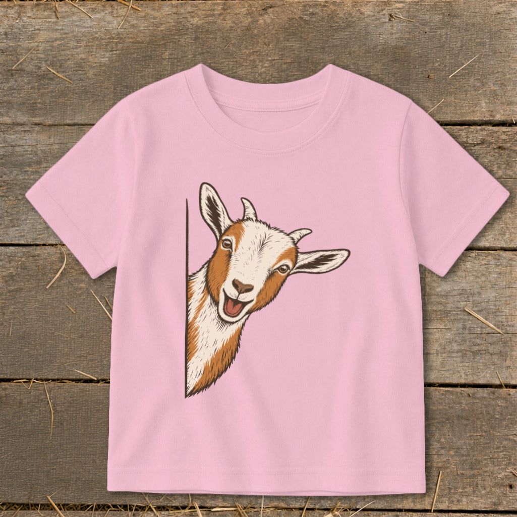 Pink t-shirt with cartoon goat peeking from the side.