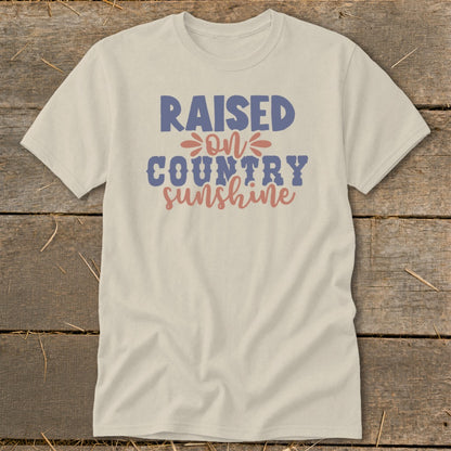 Cream t-shirt with "Raised on Country Sunshine" text in blue and coral.