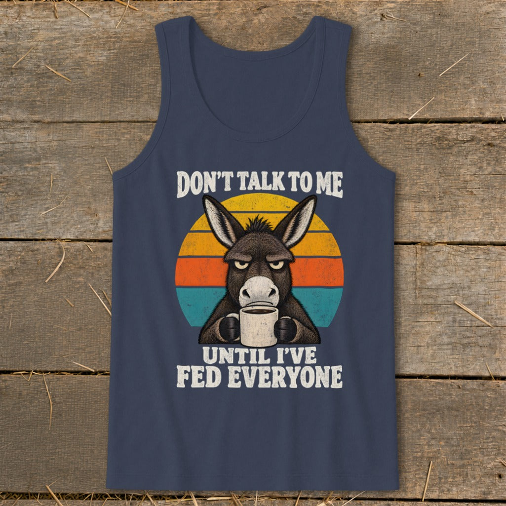 Dark blue tank top featuring a graphic of a grumpy donkey holding a coffee mug against a retro sunset.