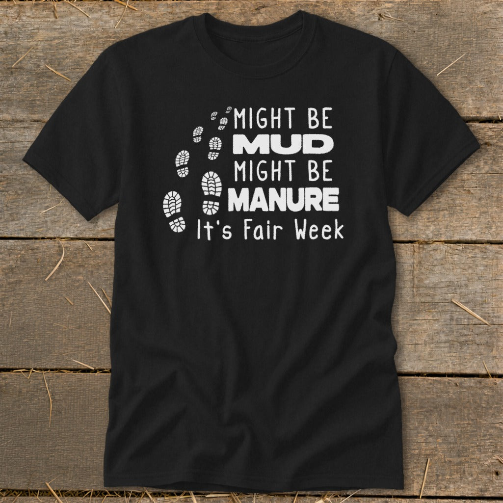 Black t-shirt with white text and boot prints reading "Might Be Mud Might Be Manure It's Fair Week."