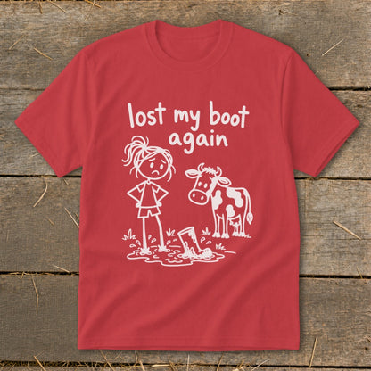 Red short-sleeve t-shirt with a white graphic of a sad cowgirl in mud next to a cow.
