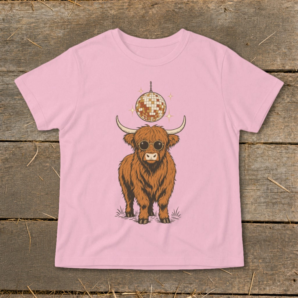 Highland cow wearing sunglasses with disco ball above on a pink t-shirt.