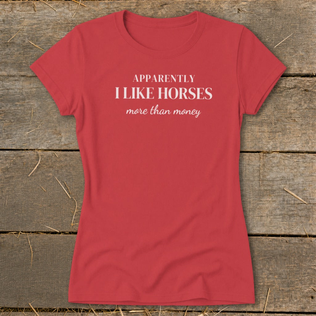 Red t-shirt with white text reading "APPARENTLY I LIKE HORSES more than money."