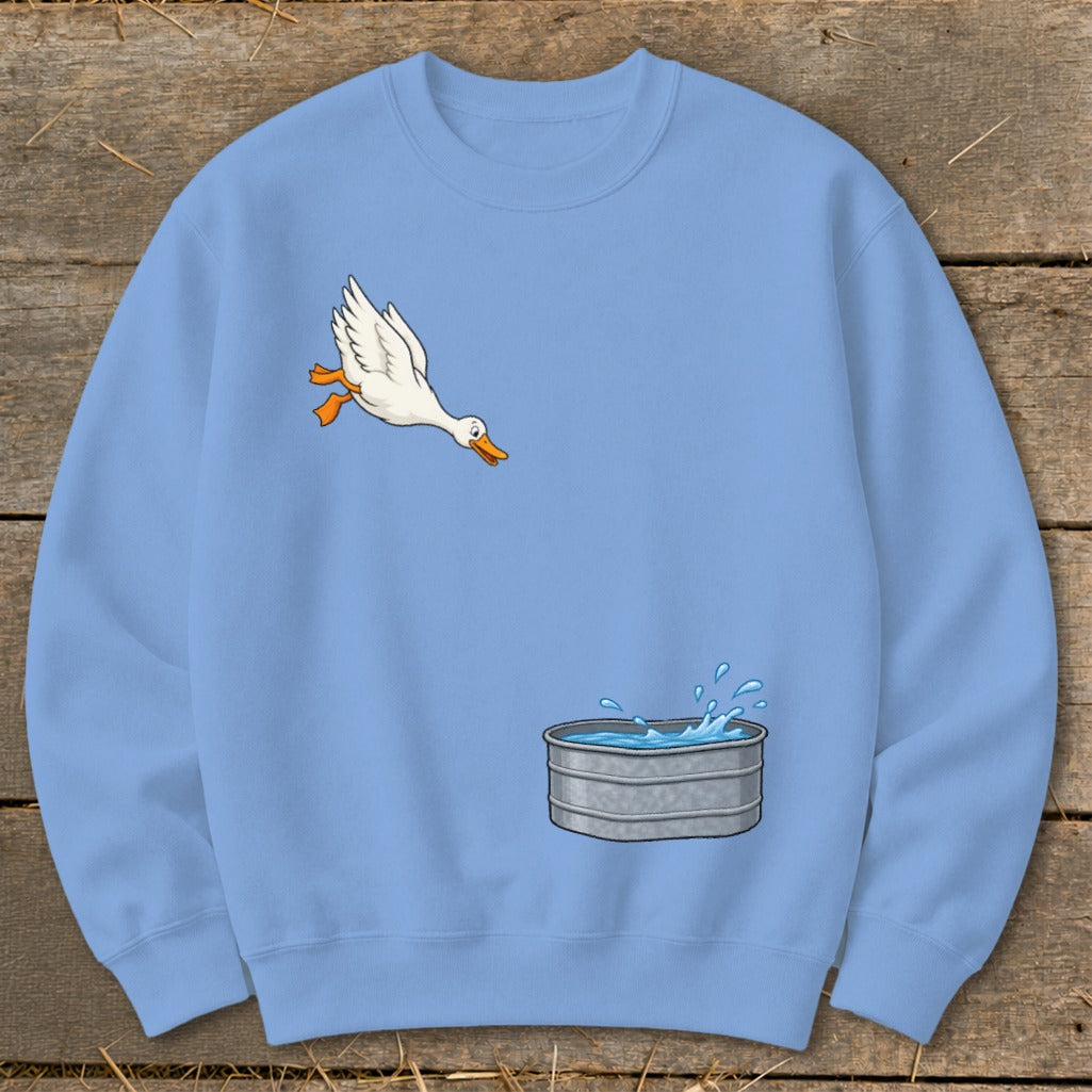 Light blue sweatshirt with cartoon duck jumping into a water trough.
