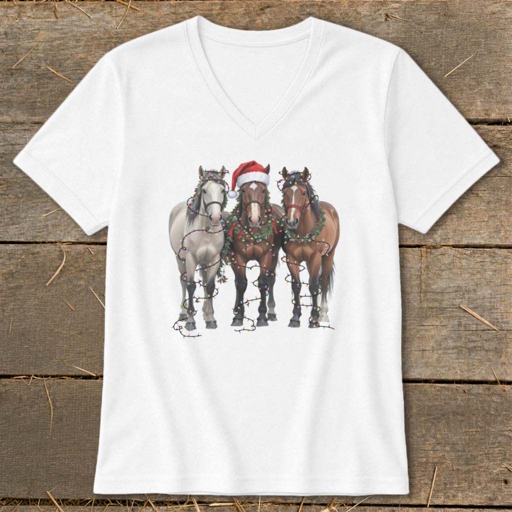 White v-neck t-shirt featuring three horses decorated with Christmas lights and garland.