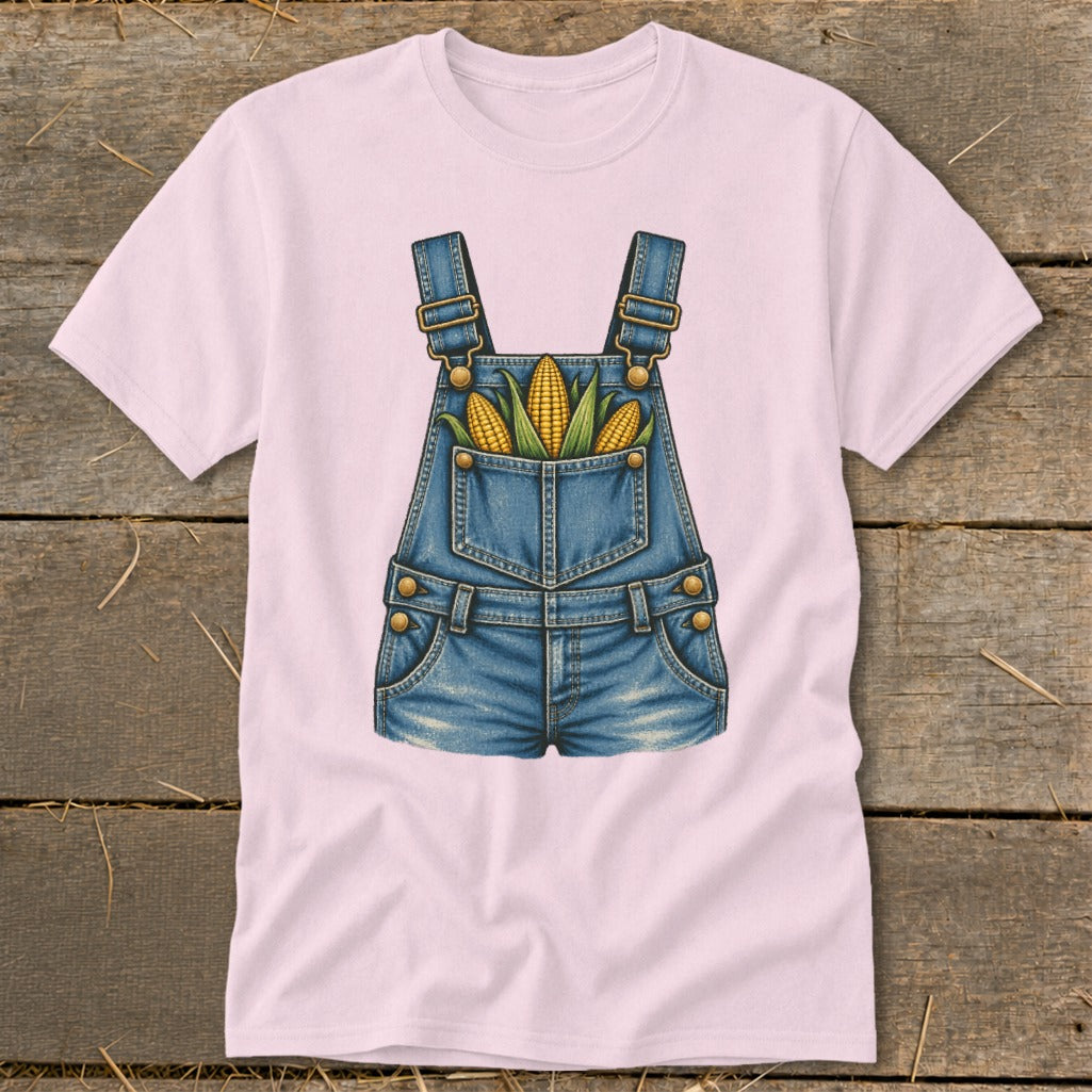 Pink t-shirt with a graphic of denim overalls filled with corn on the cob.