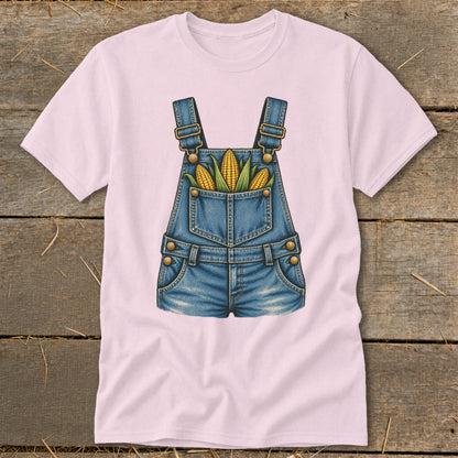 Pink t-shirt with a graphic of denim overalls filled with corn on the cob.