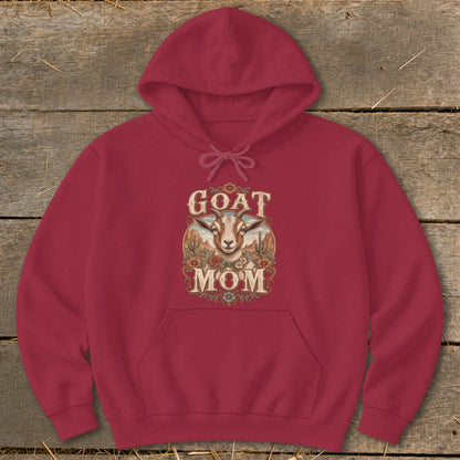 Maroon hoodie with "GOAT MOM" text and goat illustration on rustic background.