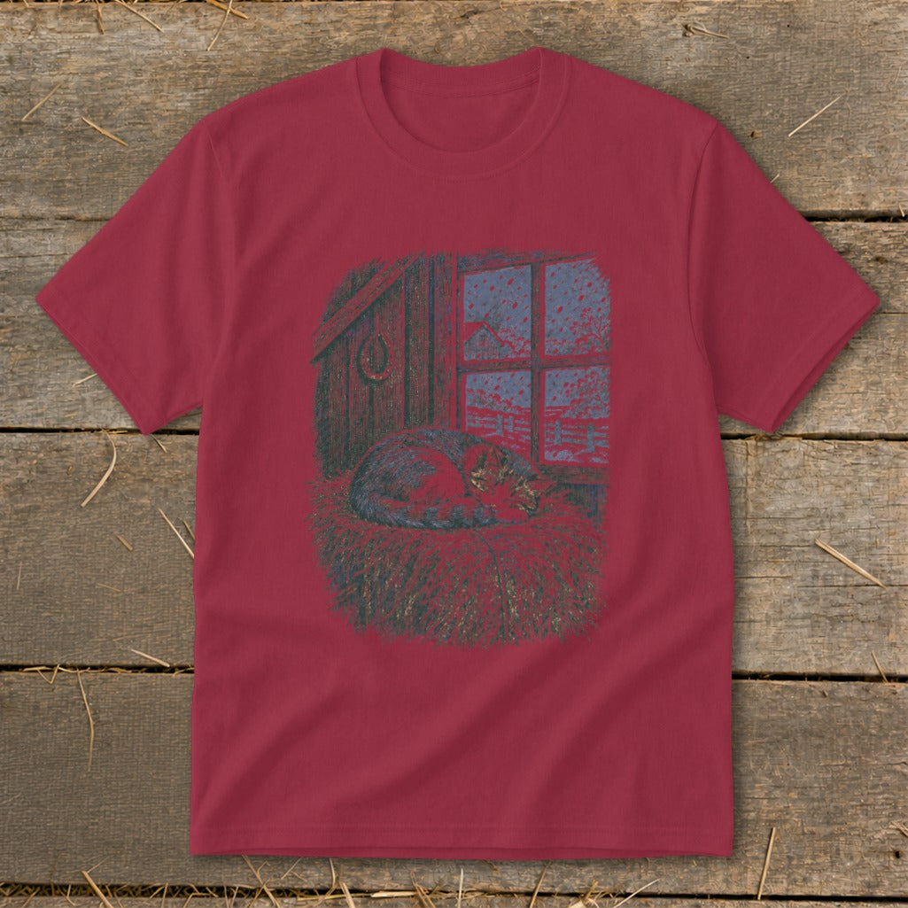 T-shirt graphic: cat sleeping on hay in barn by snowy window.