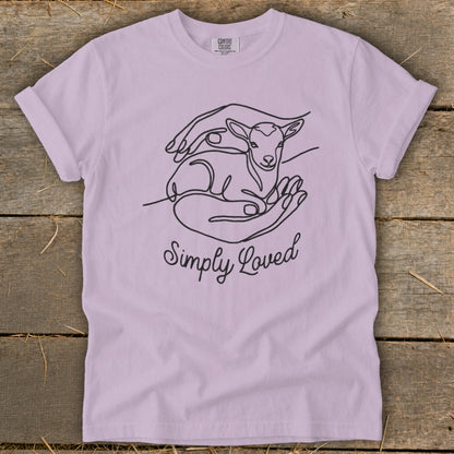 Purple t-shirt with line art of lamb in hands and text "Simply Loved".