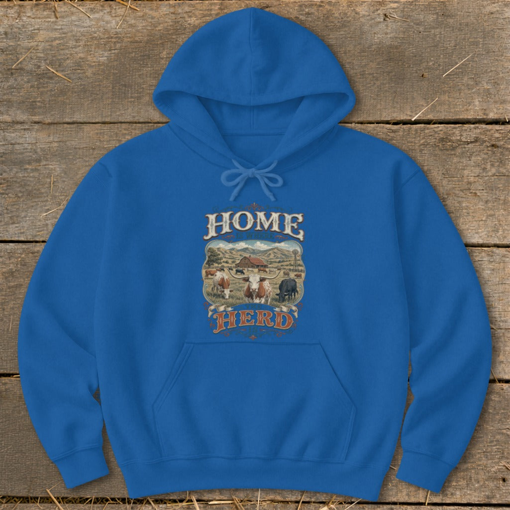 Blue hoodie with "HOME IS WHERE THE HERD IS" graphic featuring cows and a farm scene.