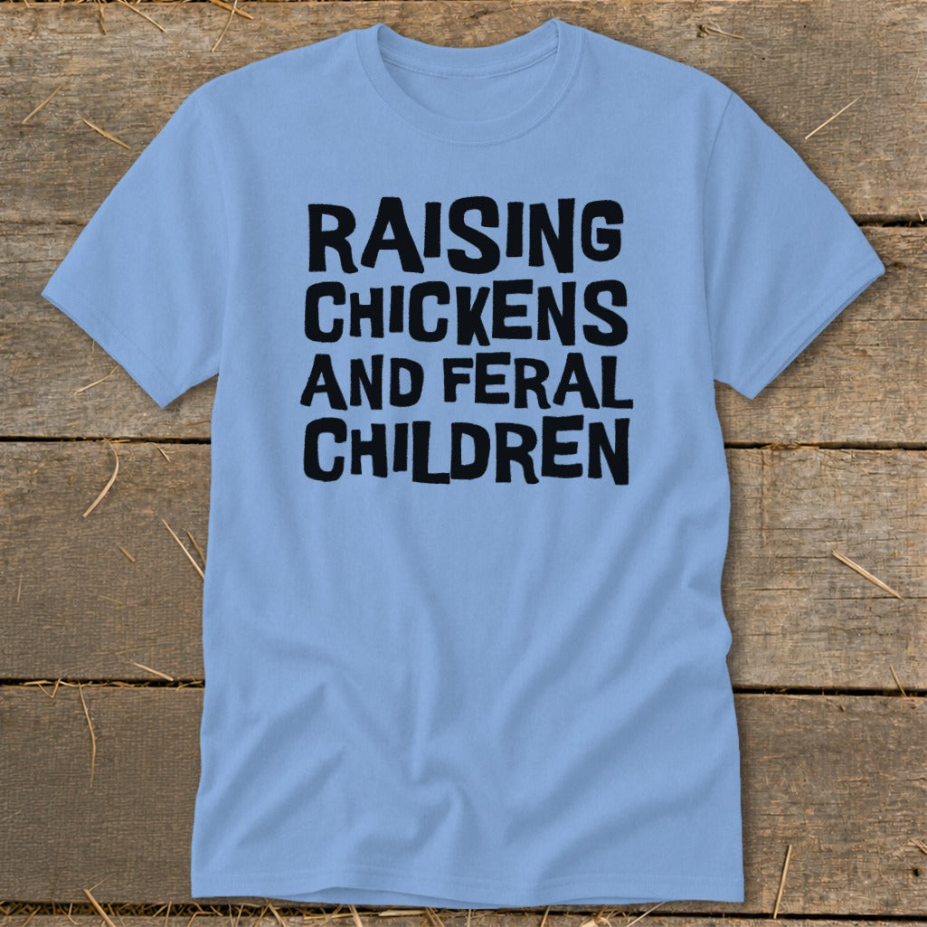 Light blue t-shirt with black text reading "RAISING CHICKENS AND FERAL CHILDREN".