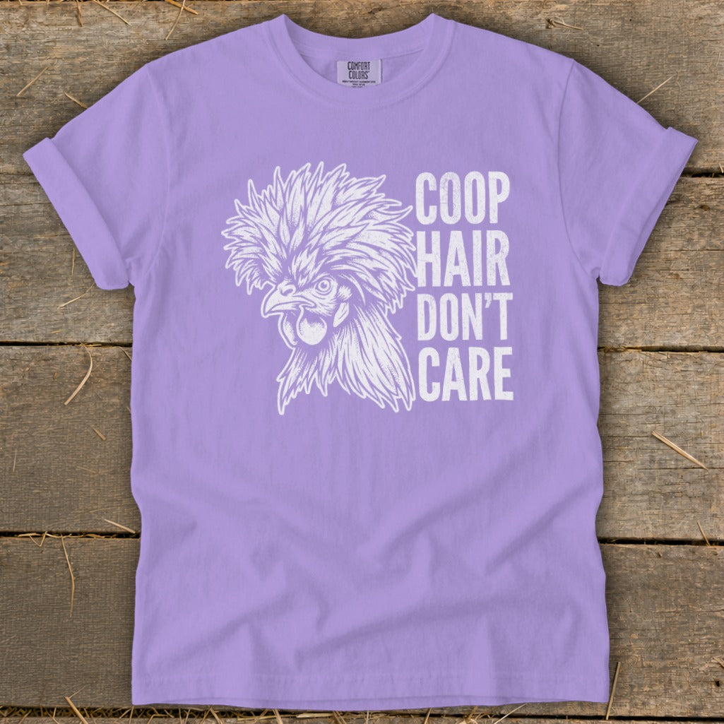 Lavender t-shirt with white graphic of a fluffy chicken and text "Coop Hair Don't Care".