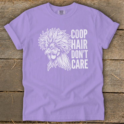 Lavender t-shirt with white graphic of a fluffy chicken and text "Coop Hair Don't Care".