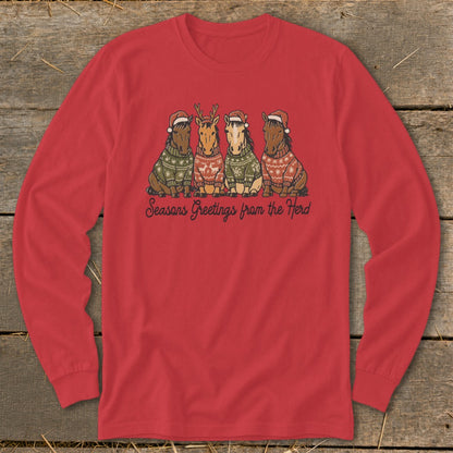 Four horses wearing Santa hats and patterned sweaters with text "Seasons Greetings from the Herd".