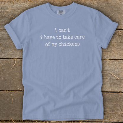 Light blue t-shirt with white text "i can't i have to take care of my chickens".