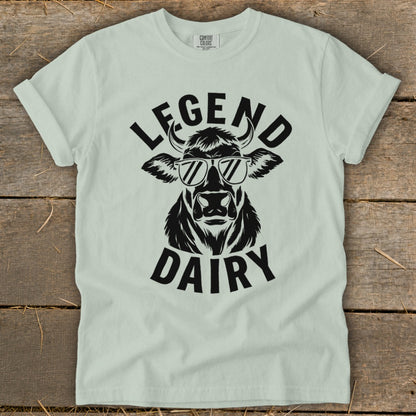 Light green t-shirt with black graphic of cow wearing sunglasses and text "LEGEND DAIRY".