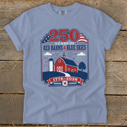 Blue t-shirt celebrating 250 years with a red barn, silo, fireworks, and American flag.