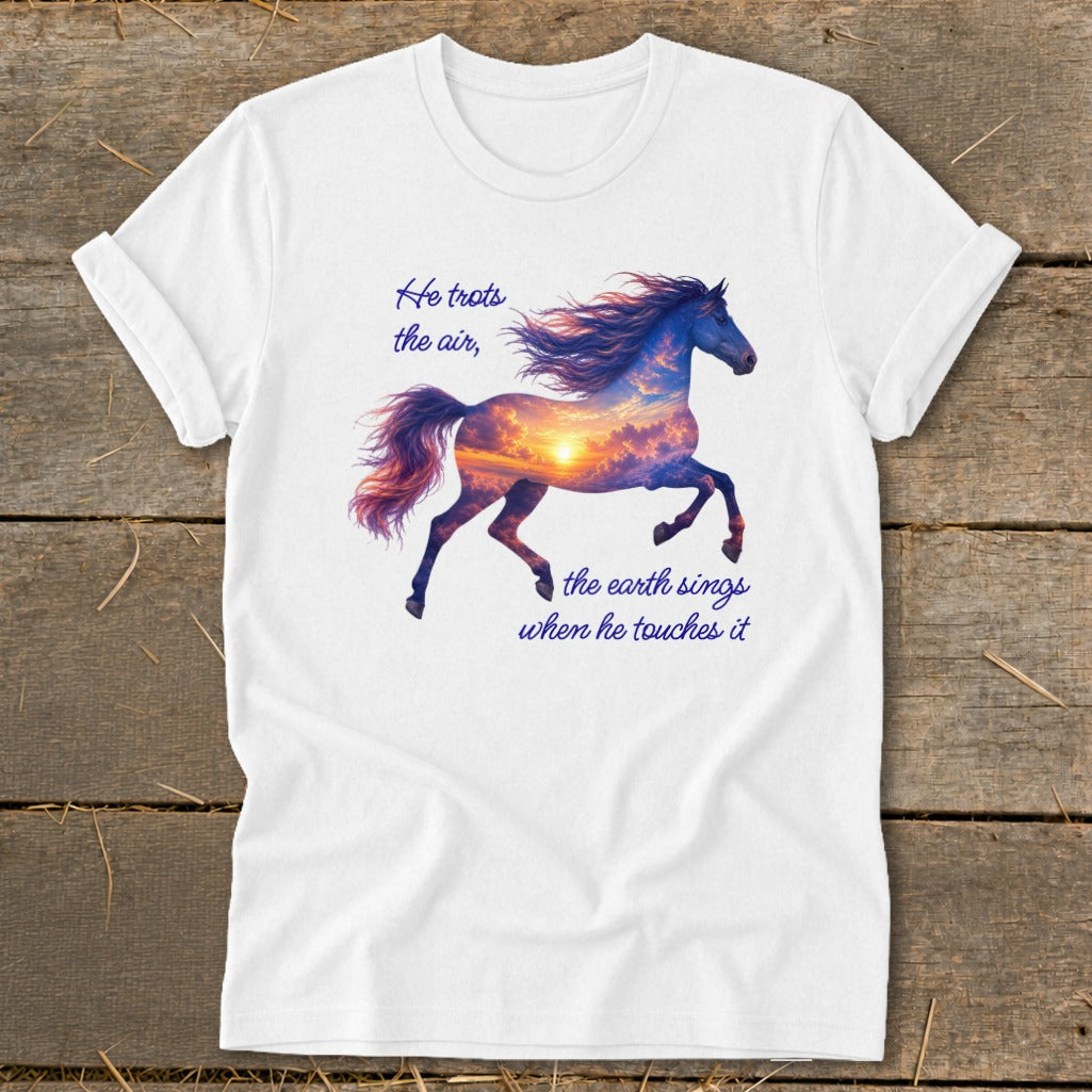 A white t-shirt features a running horse graphic filled with a sunset sky and quote text.