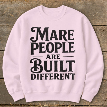 Light pink crewneck sweatshirt with black text "Mare people are built different".