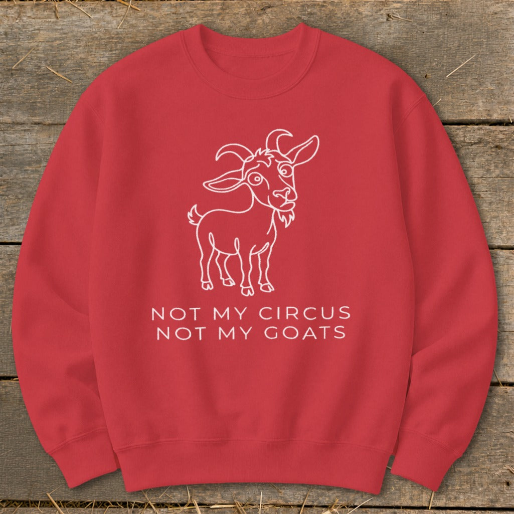 Red sweatshirt with a white outline of a goat and text "NOT MY CIRCUS NOT MY GOATS".