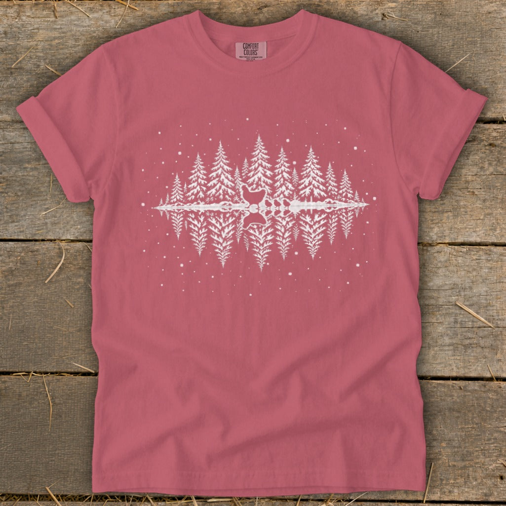 Pink t-shirt with white graphic of pine trees reflecting in water, with chickens.