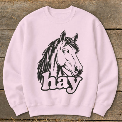 Pink sweatshirt with black horse head graphic and the word "hay."