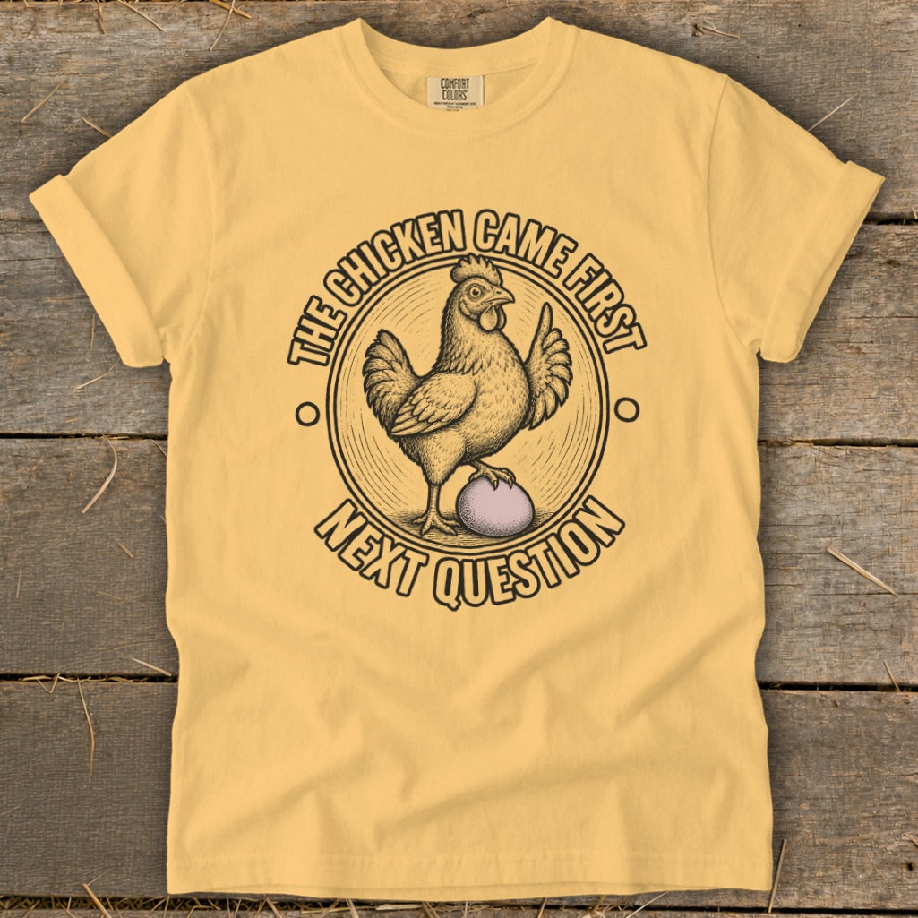 Yellow t-shirt with "The Chicken Came First, Next Question" graphic.
