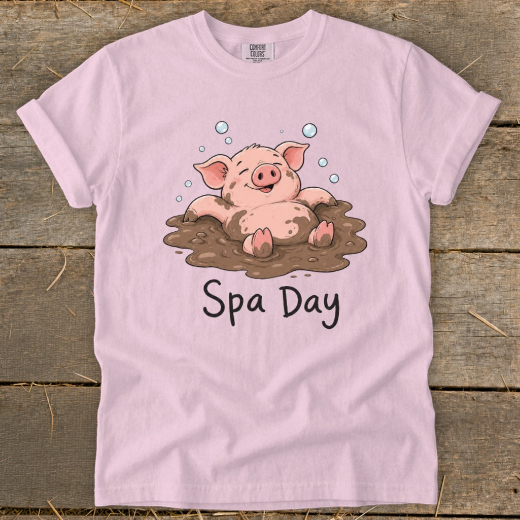 Pink t-shirt with cartoon pig in mud and text "Spa Day".