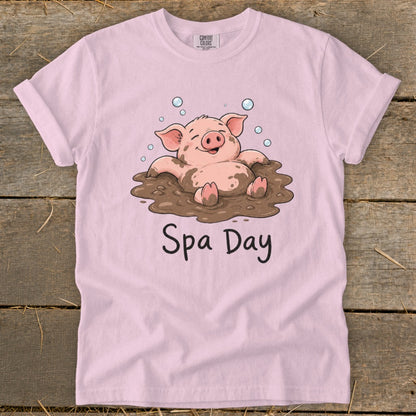 Pink t-shirt with cartoon pig in mud and text "Spa Day".