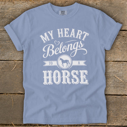 Light blue t-shirt with white text: "My heart belongs to a horse."