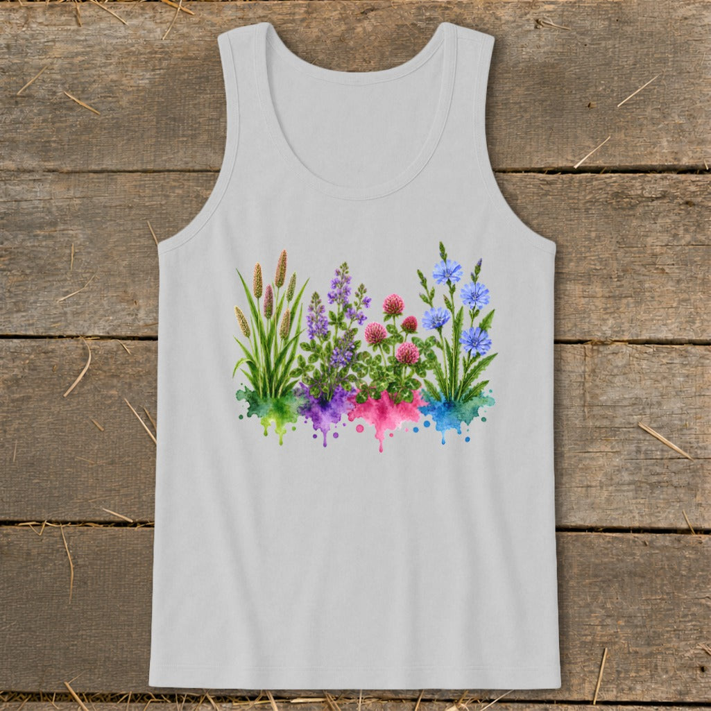 A light gray tank top with a watercolor graphic of four clusters of wildflowers over corresponding colored splatters, laid flat on a rustic wooden surface.