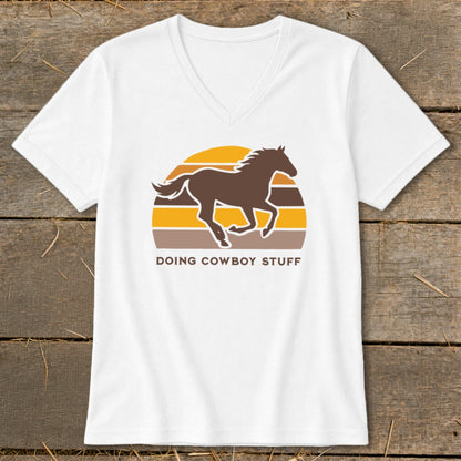 White t-shirt with brown horse silhouette and retro sunset graphic, text "DOING COWBOY STUFF".