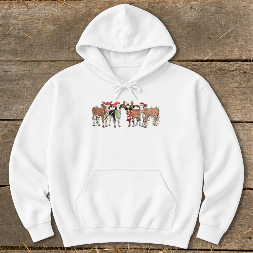 White hoodie with a festive print of cows wearing Santa hats and Christmas lights.