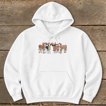 White hoodie with a festive print of cows wearing Santa hats and Christmas lights.