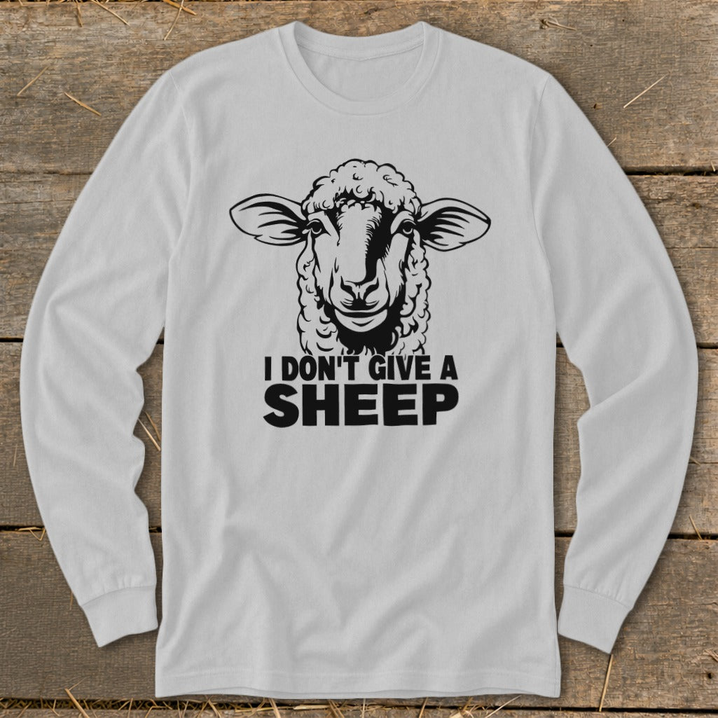 White long-sleeve shirt with a black graphic of a sheep and text that reads "I DON'T GIVE A SHEEP".
